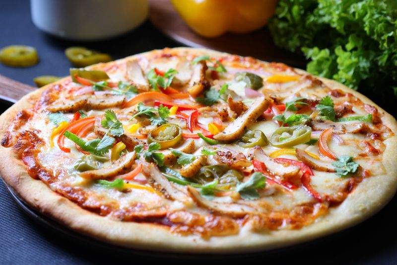 Artisan gourmet burger served alongside our signature round table pizza